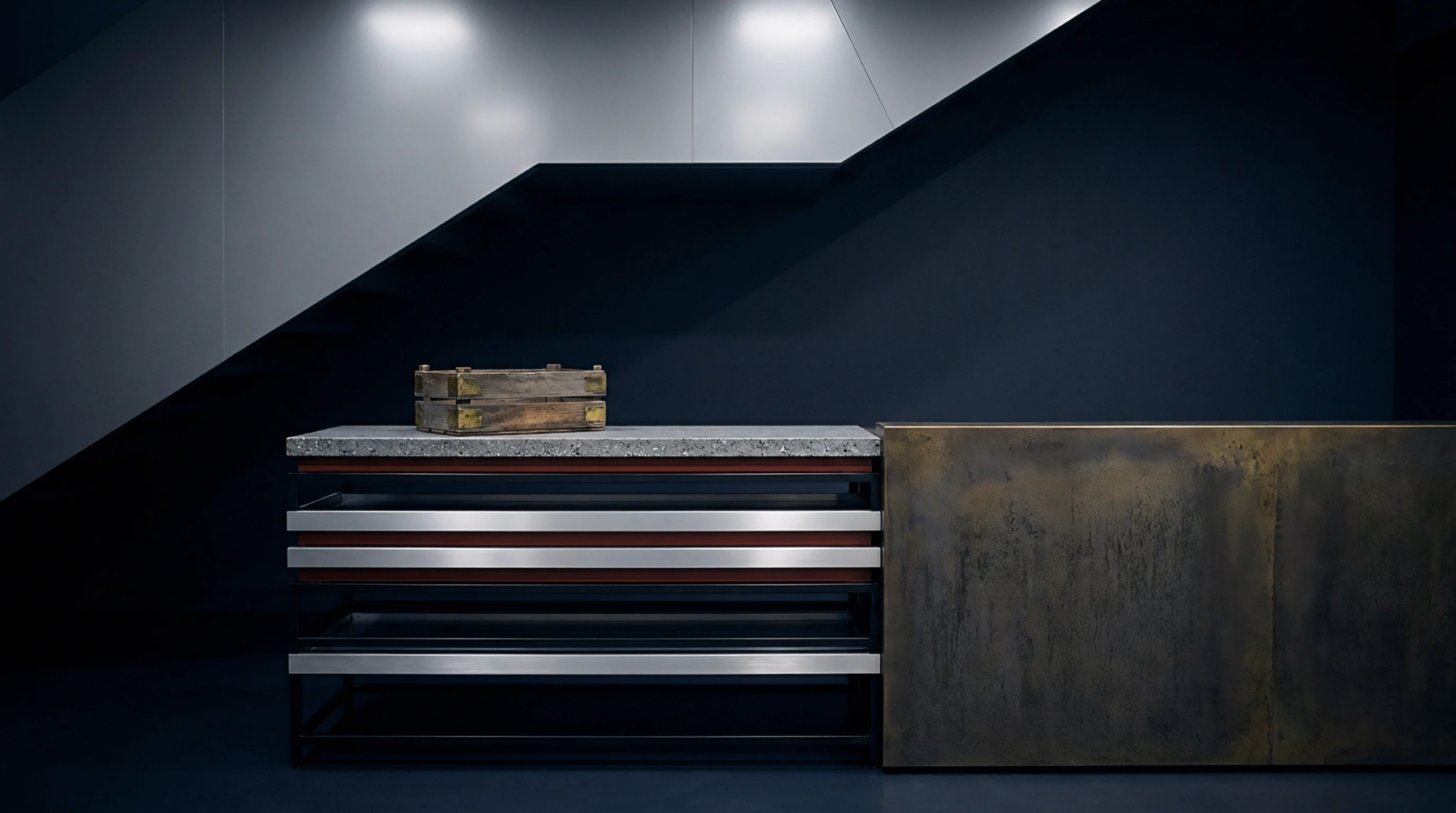 Modular storage furniture constructed from concrete and oxidized steel stands aligned beside a dark architectural bulkhead inside an industrial distribution showroom.
